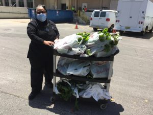 A UNC Hospitals staff person receives produce from the Carolina Community Garden.