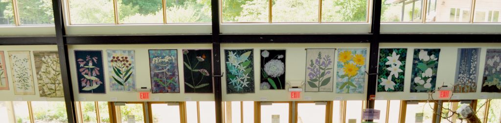 A row of decorative wildflower quilts lines the wall of our exhibit hall.