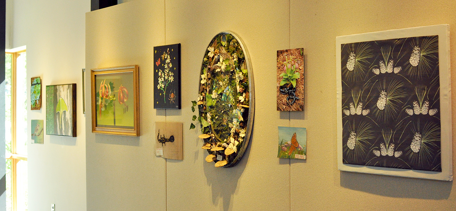 Collages, photos, paintings, fabric art, and more, hanging in the DeBerry Gallery.